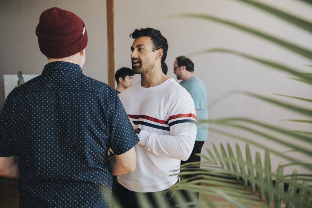 People engaging in conversation at NOLA Detox event in New Orleans.
