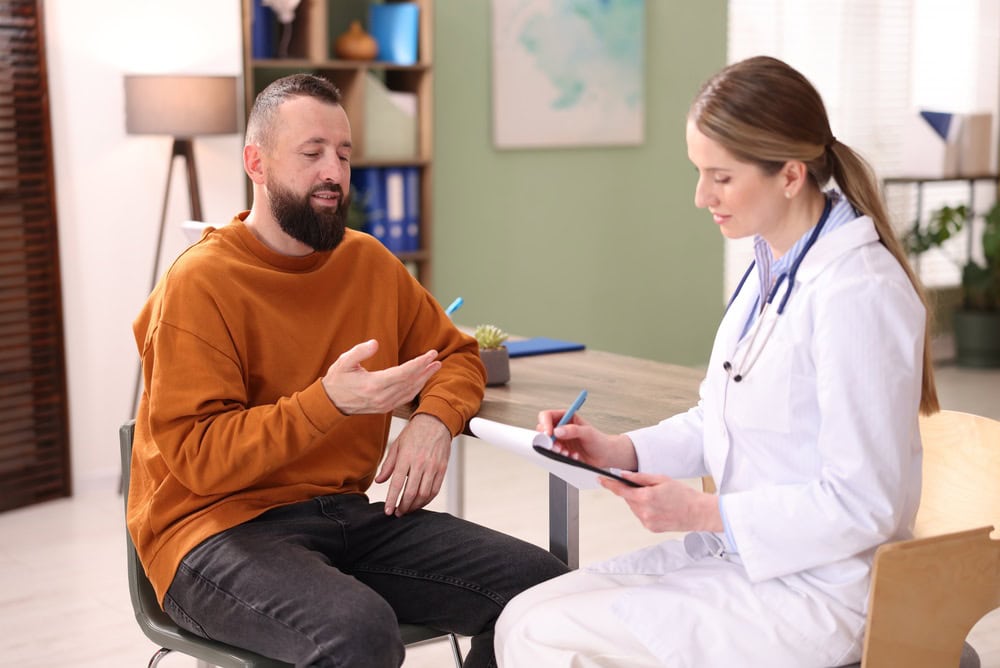man talking to insurance consolation aetna drug rehab