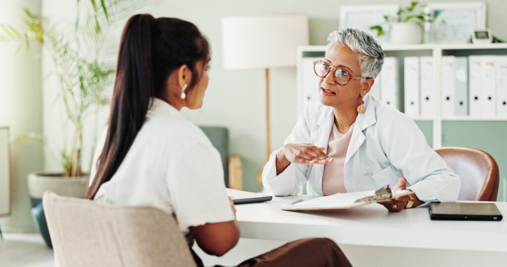 woman talking to insurance consolation optum drug rehabs
